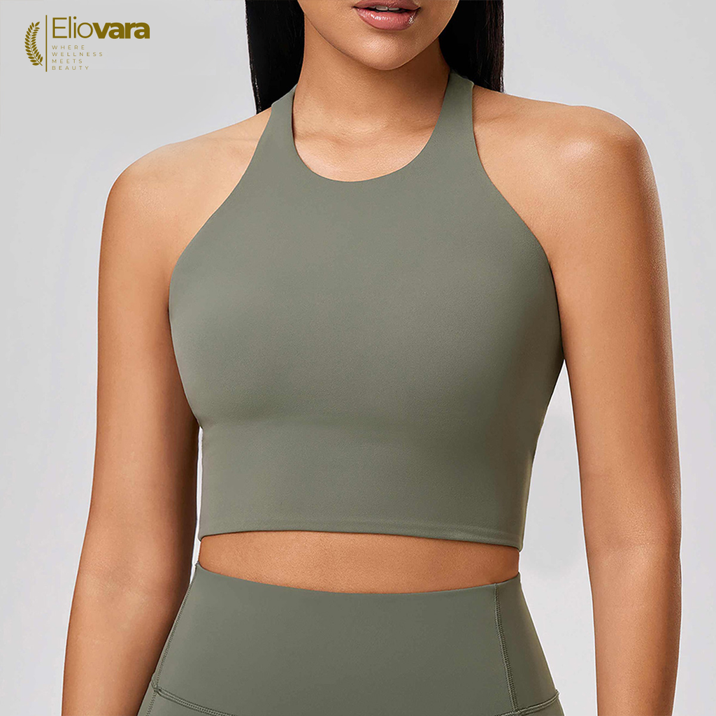 Woman wearing a green sports bra and leggings with 'Eliovara' branding.