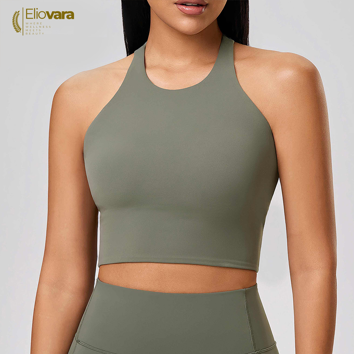Woman wearing a green sports bra and leggings with 'Eliovara' branding.